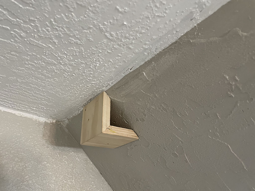 ninety degree support on angled wall