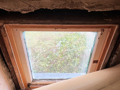 hidden window behind paneling in closet