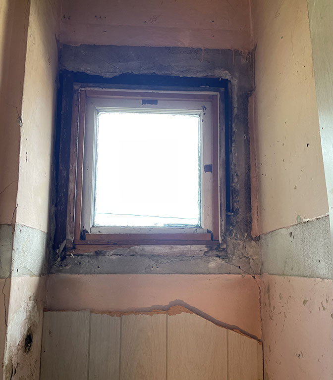 long-covered craftsman window with outline of original trim