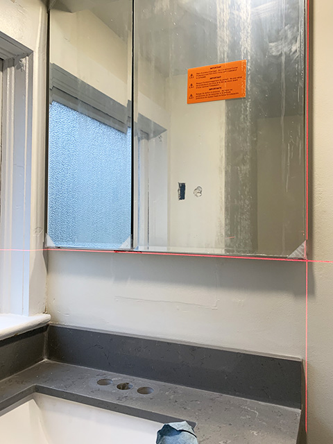 Laser level showing position of cabinet