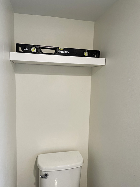 floating shelf above toilet to add storage to small bathroom