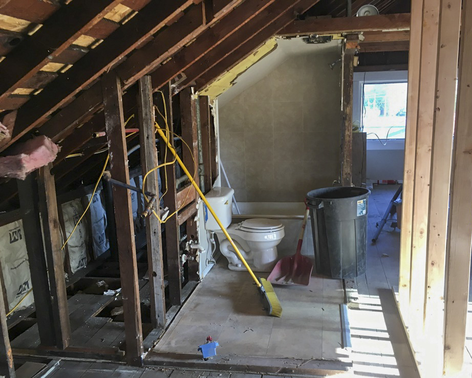 bathroom that is gutted with only toilet remaining